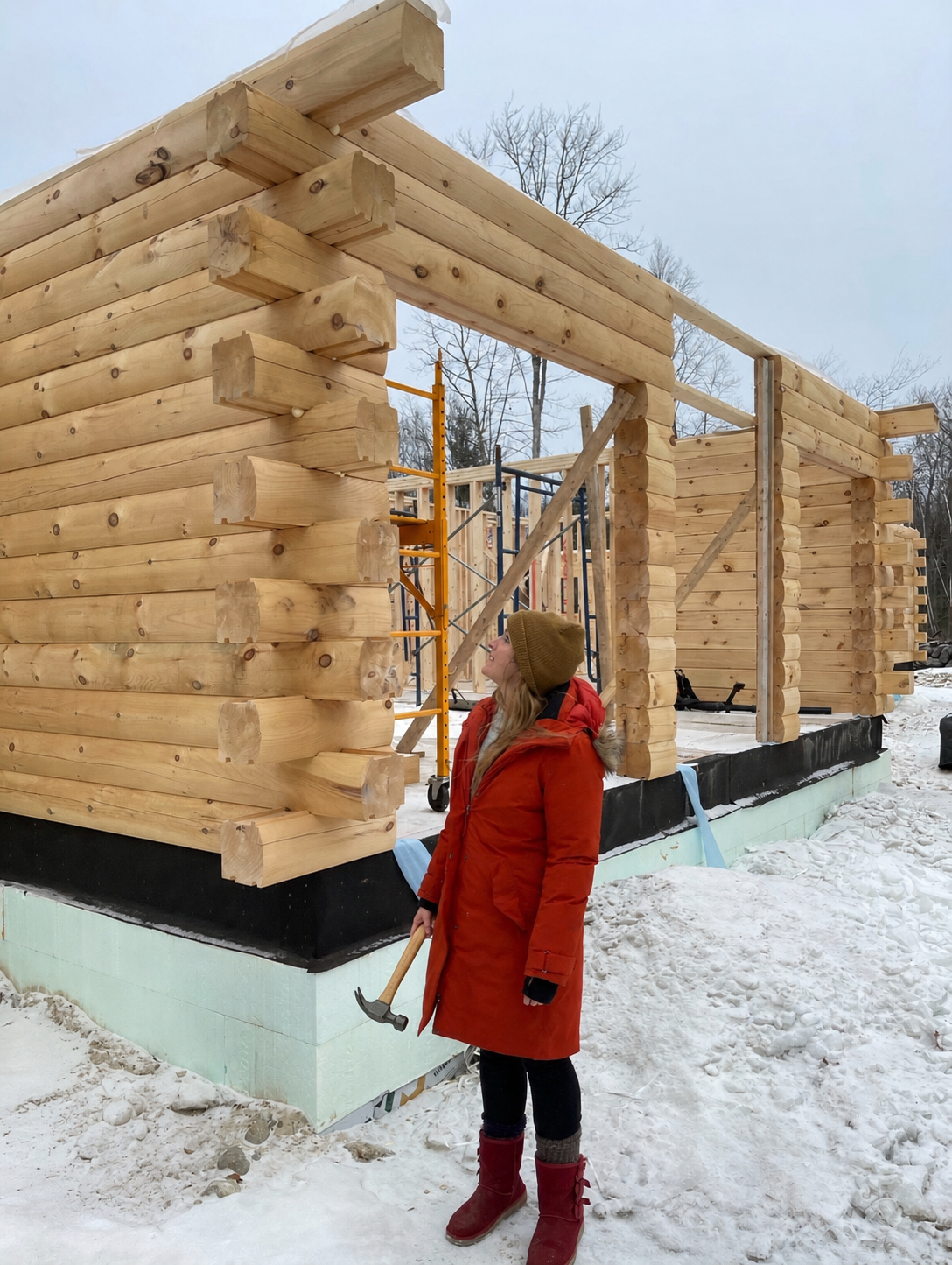 Stacked Merrimac Eastern White Pine log walls with hand-fit corner notches during winter build