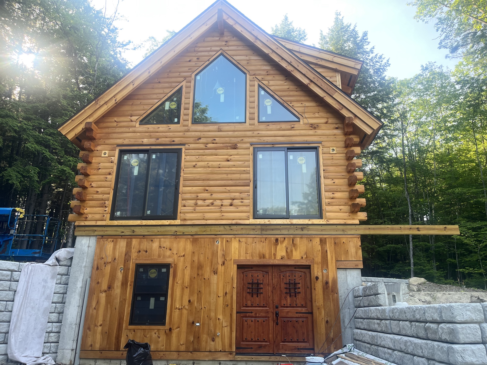 The Freedom log home mid-construction with Pella windows and double front doors