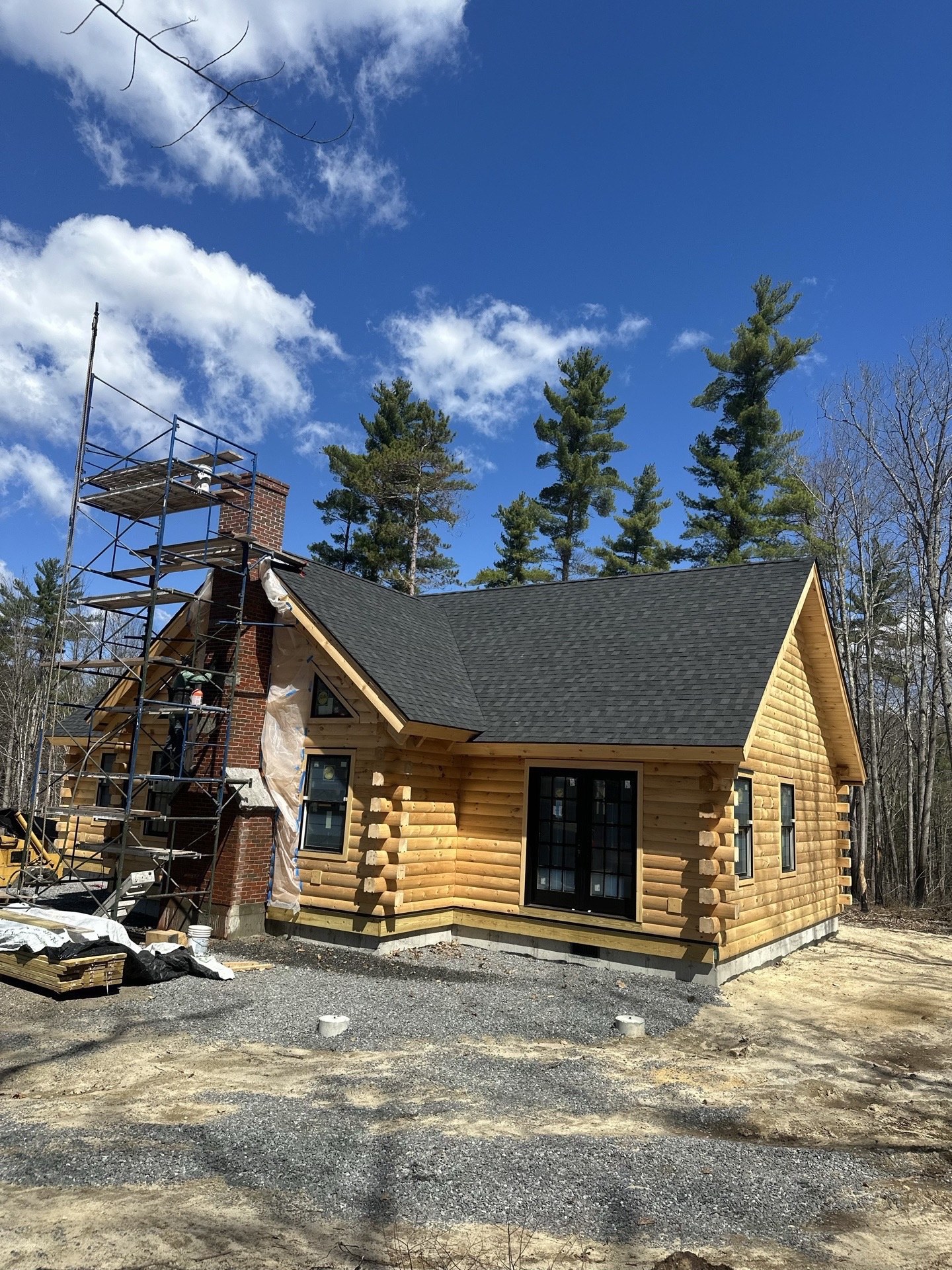 Side view of the Little Sunapee during construction with scaffolding around the brick chimney
