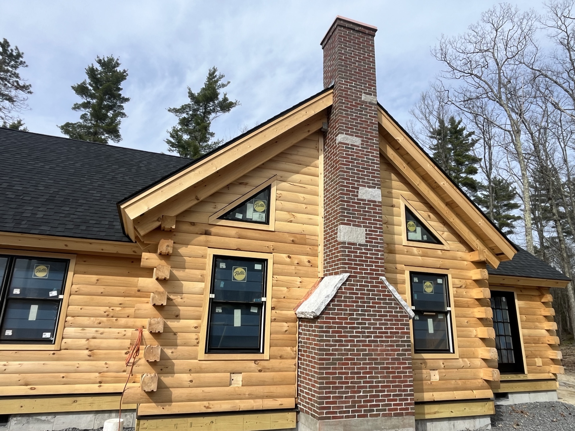 The Little Sunapee under construction with the brick chimney rising through the center and triangular gable windows on either side