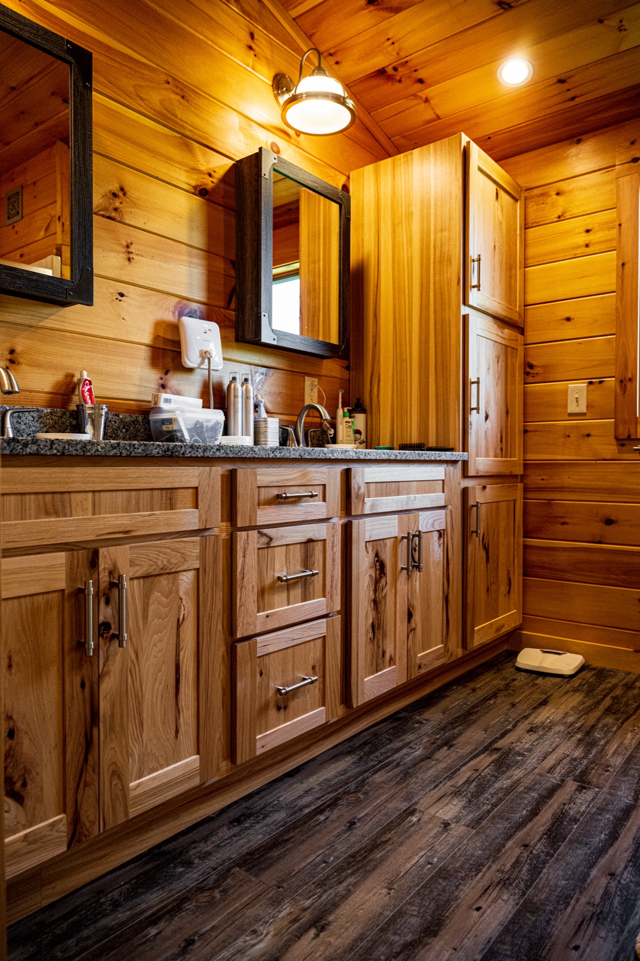 Ossipee bathroom with custom hickory vanity, granite counter, and mirror cabinet