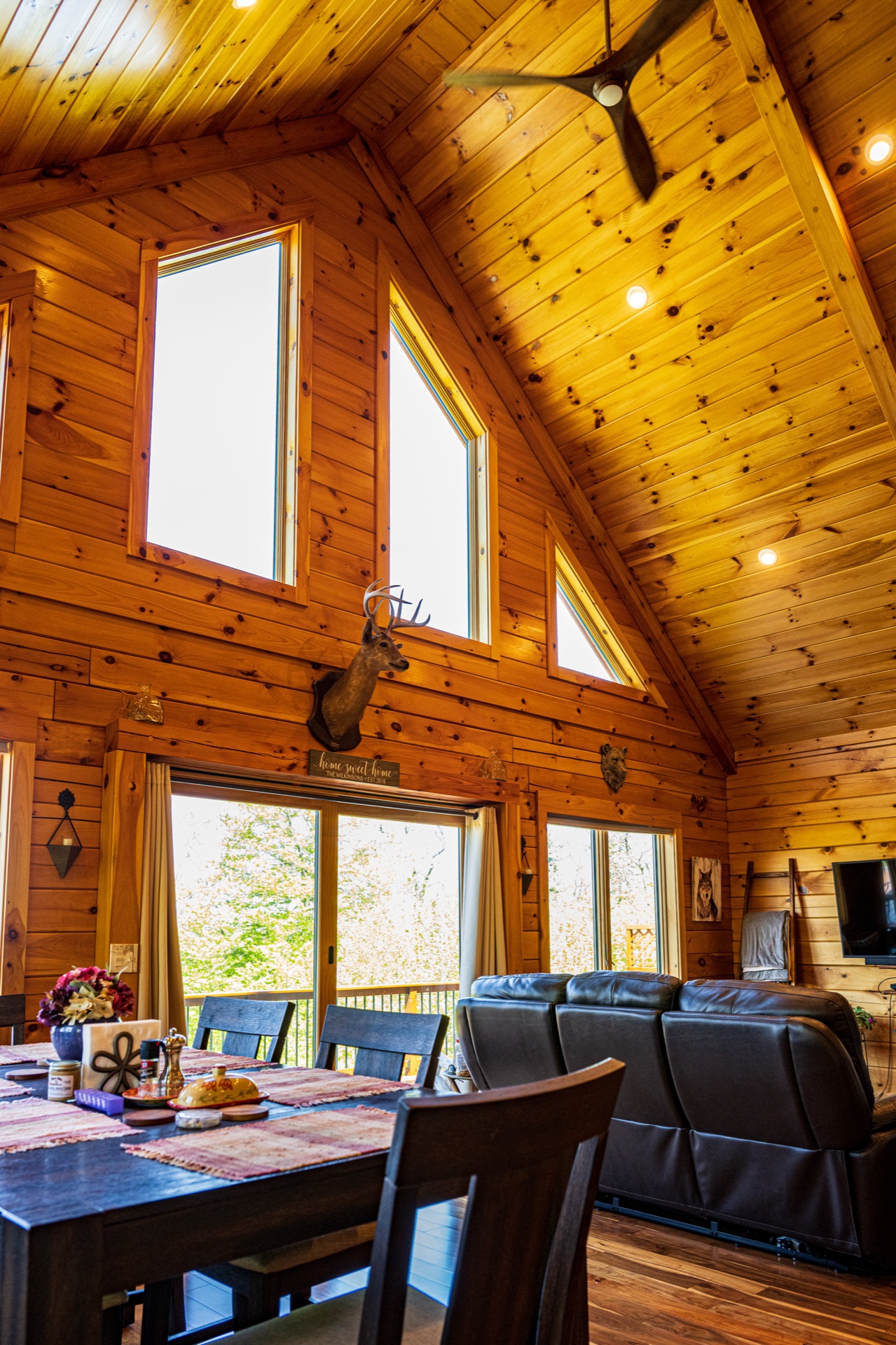 Ossipee dining area under cathedral ceiling with chalet windows and deer mount