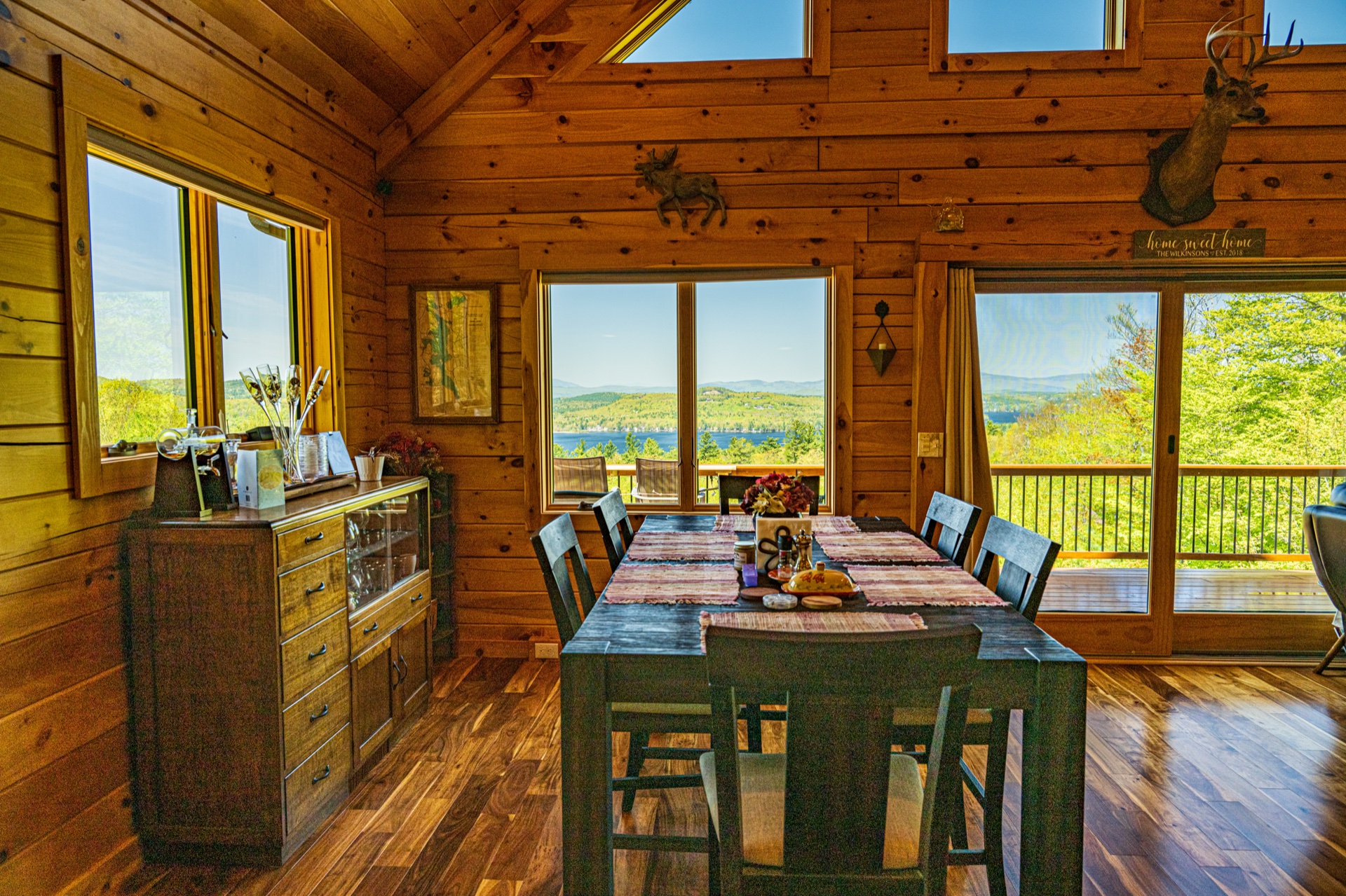 Ossipee dining table with lake and mountain view through chalet windows