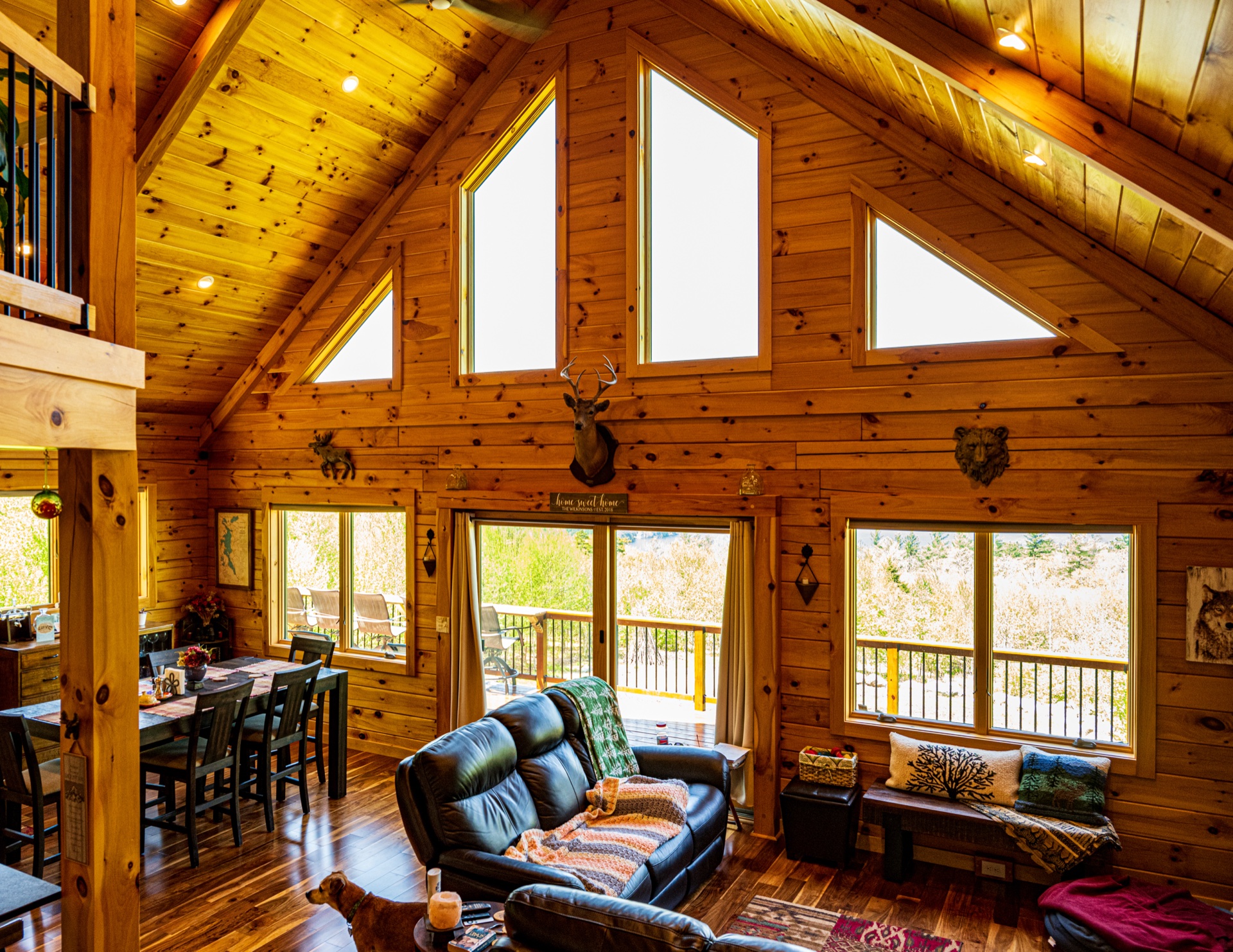 Ossipee great room with cathedral ceiling, chalet windows, and leather couch