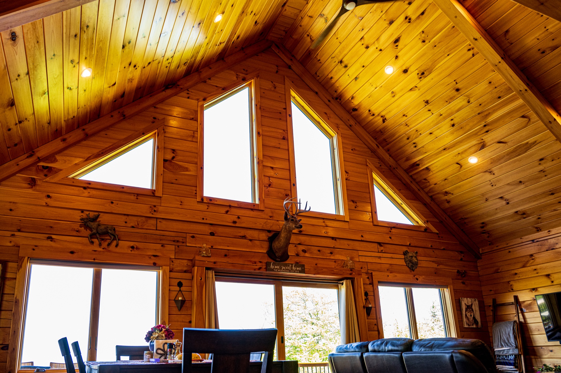 Ossipee cathedral ceiling with triangular chalet windows and deer mount