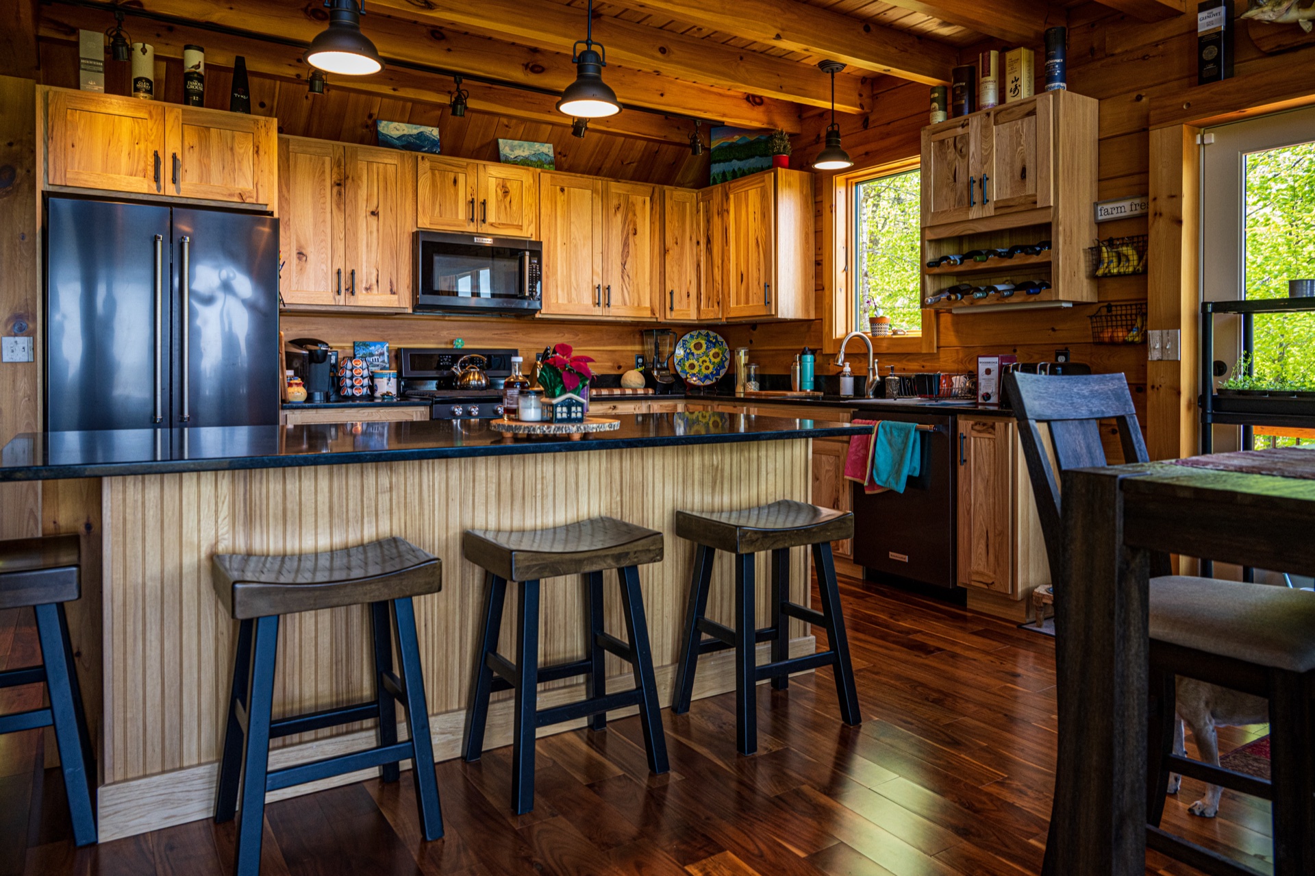 Ossipee kitchen island with granite counter and three wood bar stools