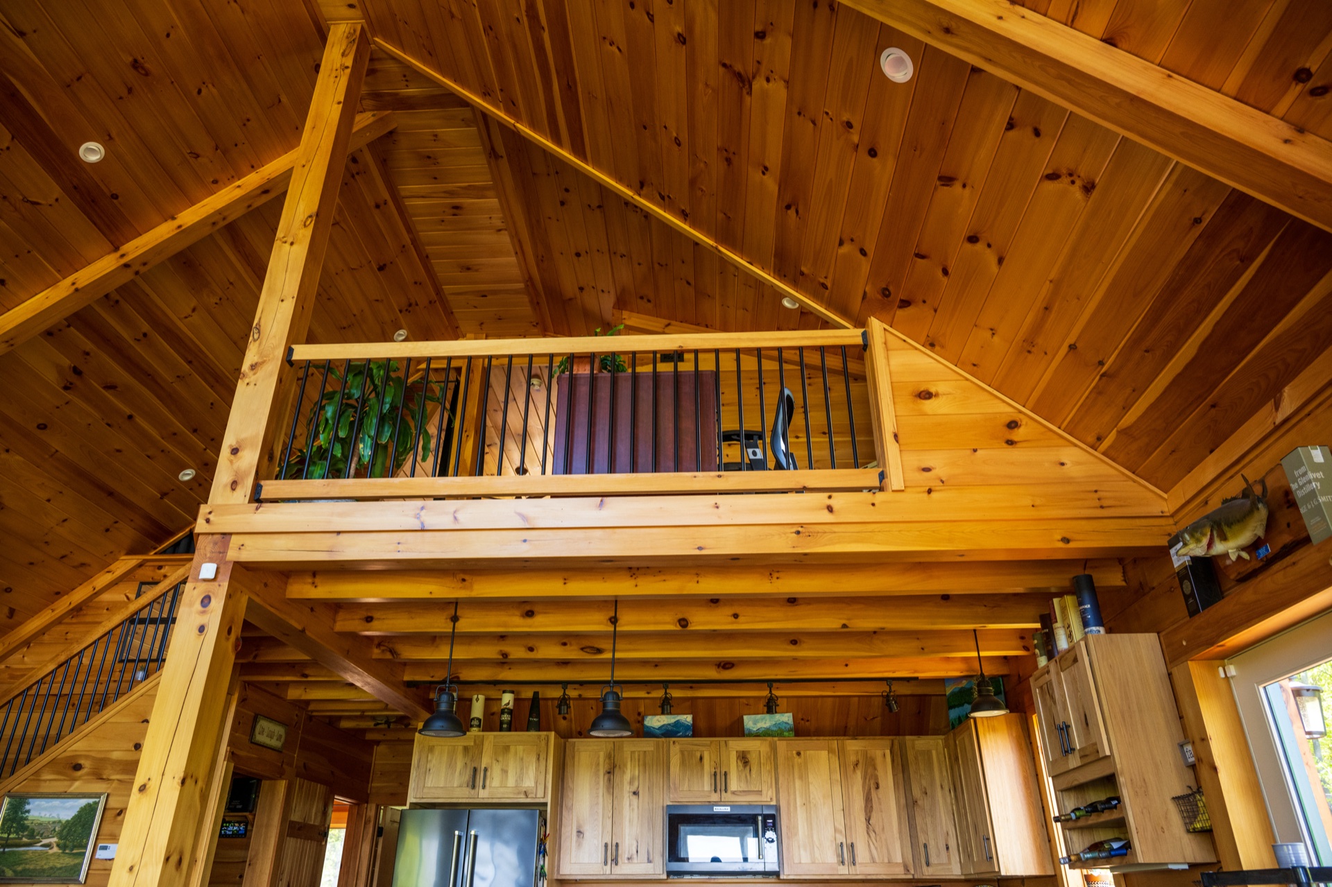 Ossipee loft railing and cathedral ceiling viewed from the kitchen