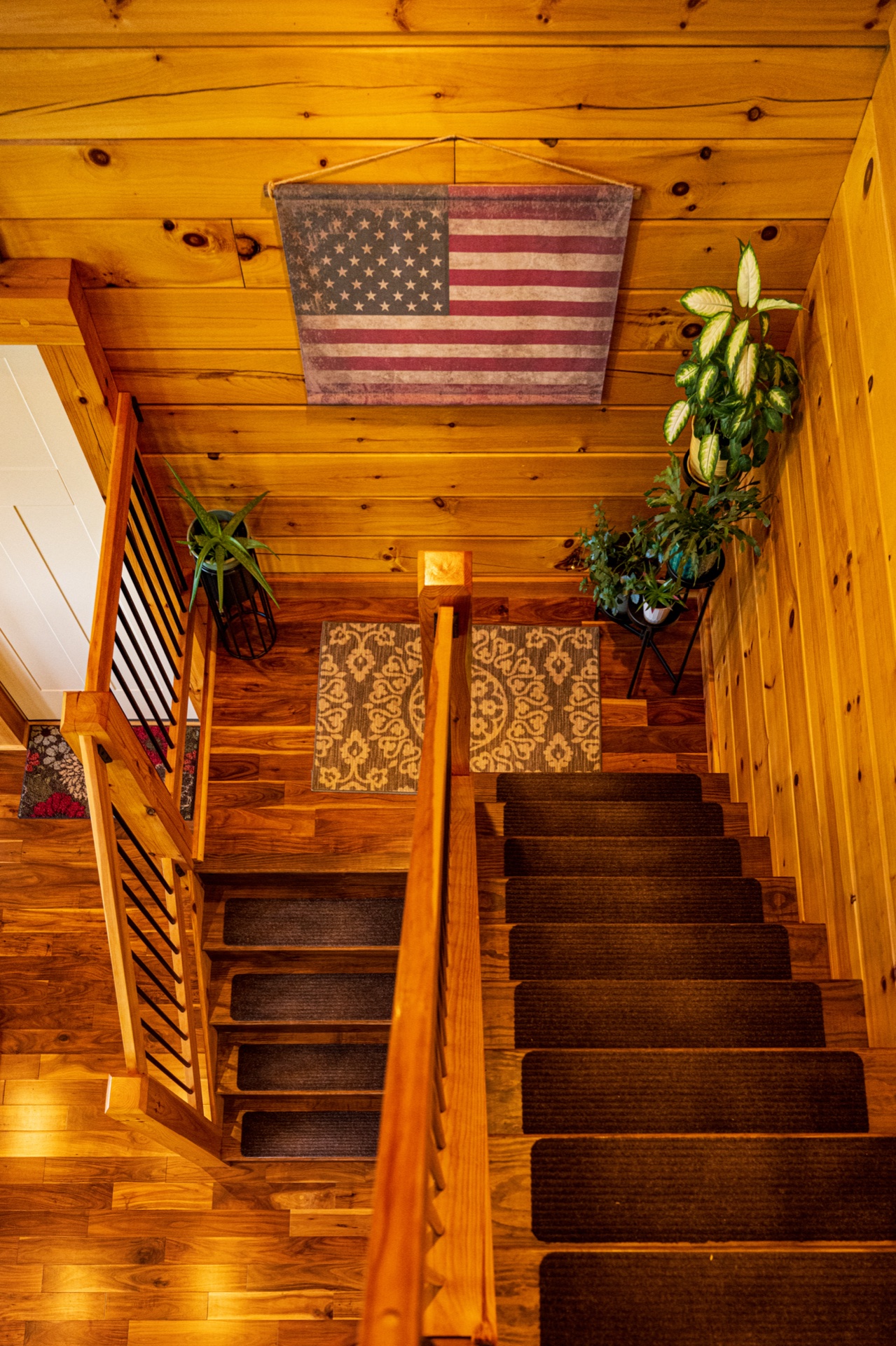 Ossipee staircase with stair runner and American flag wall hanging