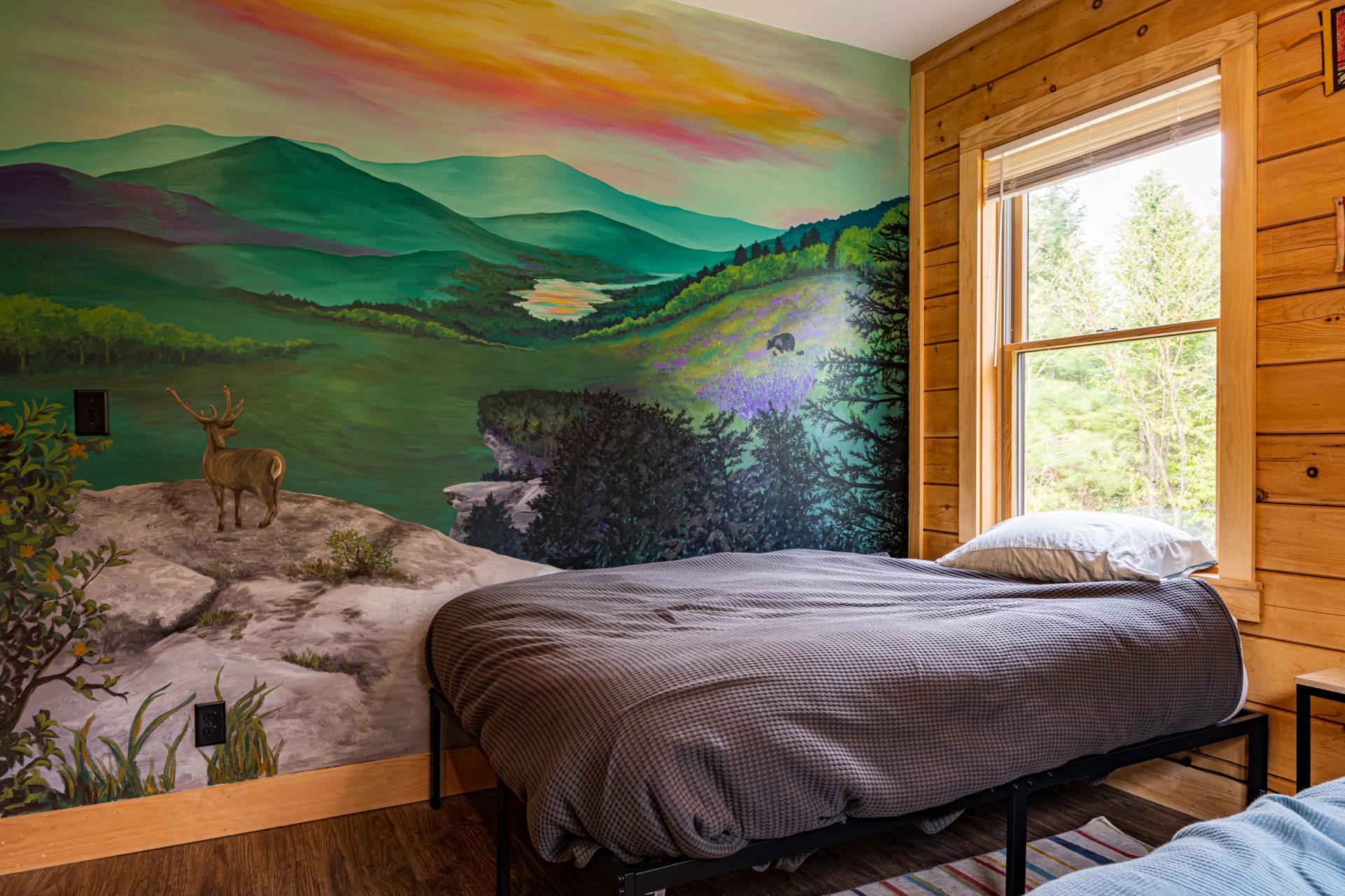 Sunapee bedroom with hand-painted mountain landscape mural and deer figurine