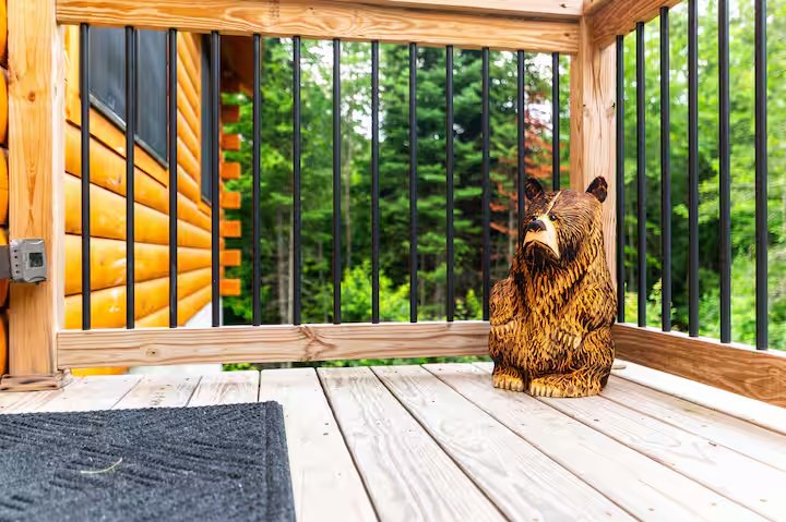 Hand-carved wooden bear sculpture on the Sunapee deck
