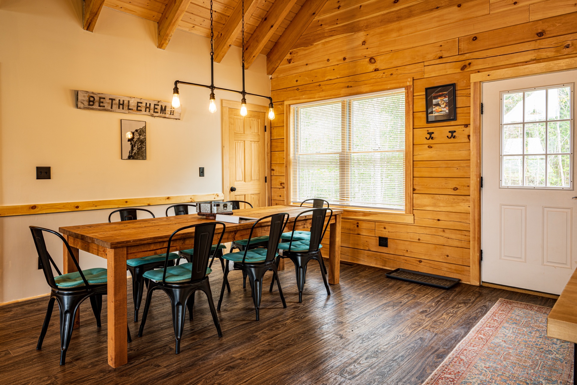 Sunapee dining area with farmhouse table and BETHLEHEM sign