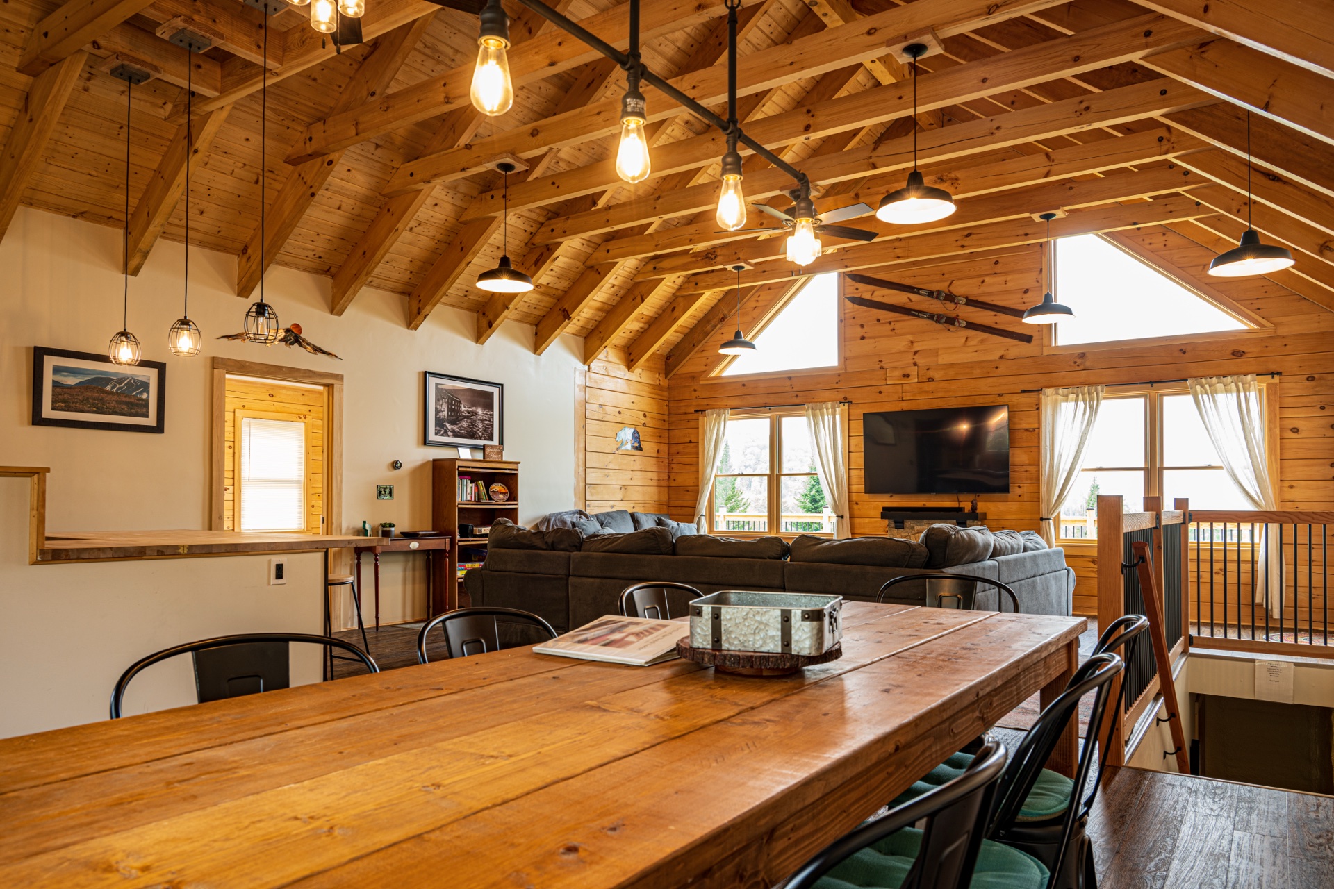 Sunapee dining room with farmhouse table and Edison-bulb chandelier