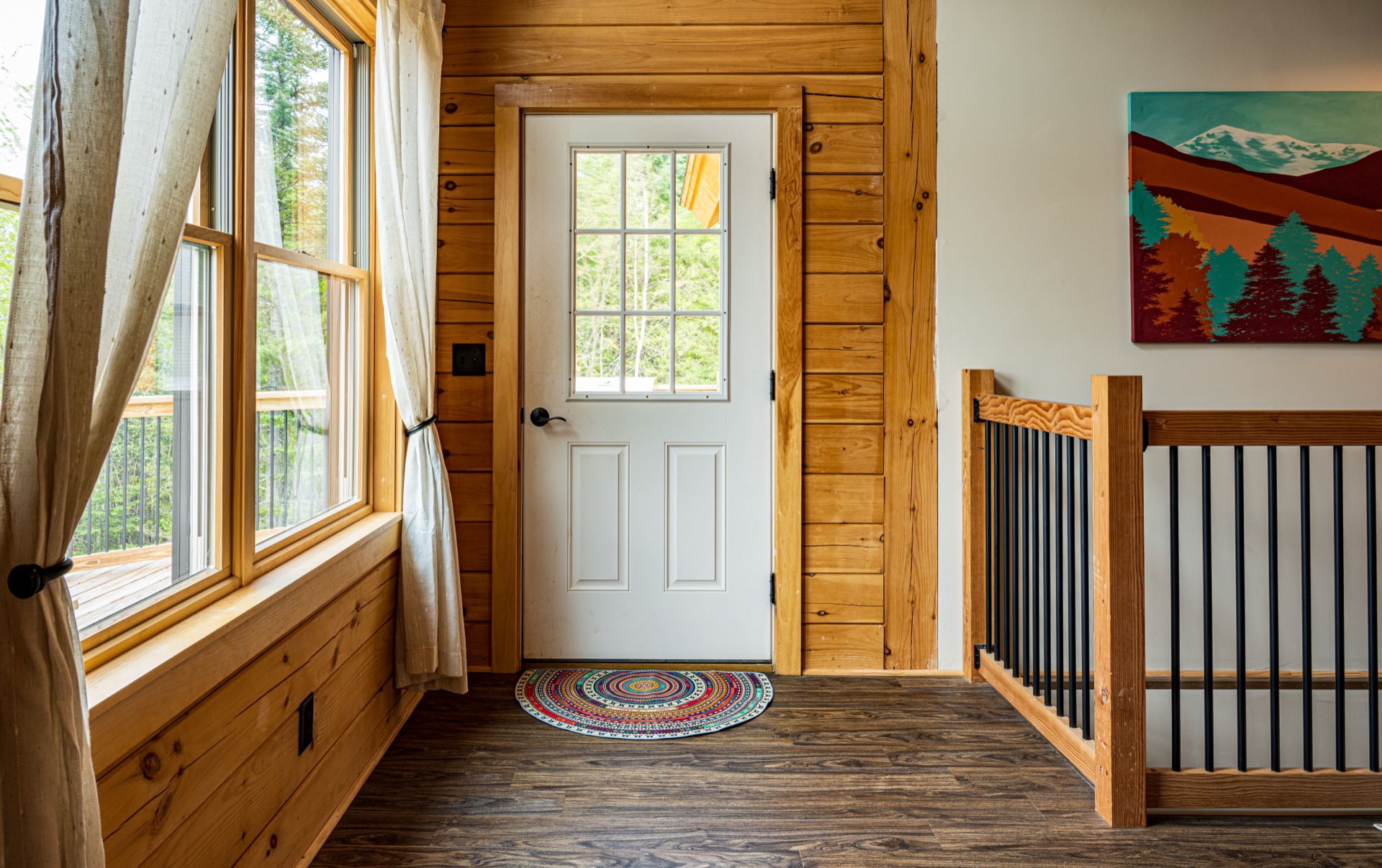Sunapee entry foyer with white front door and mountain artwork