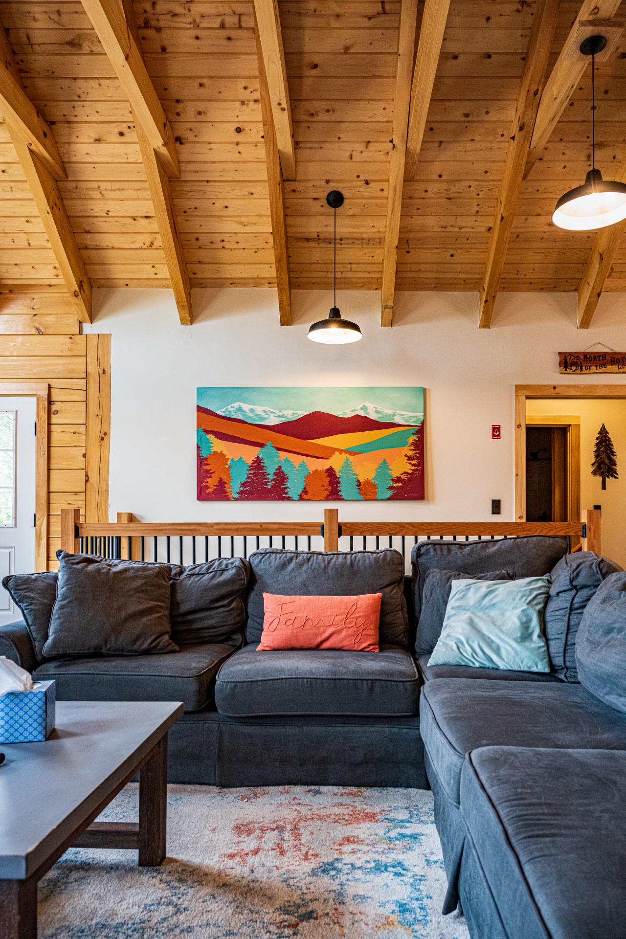 Sunapee great room with mountain landscape art over the sectional