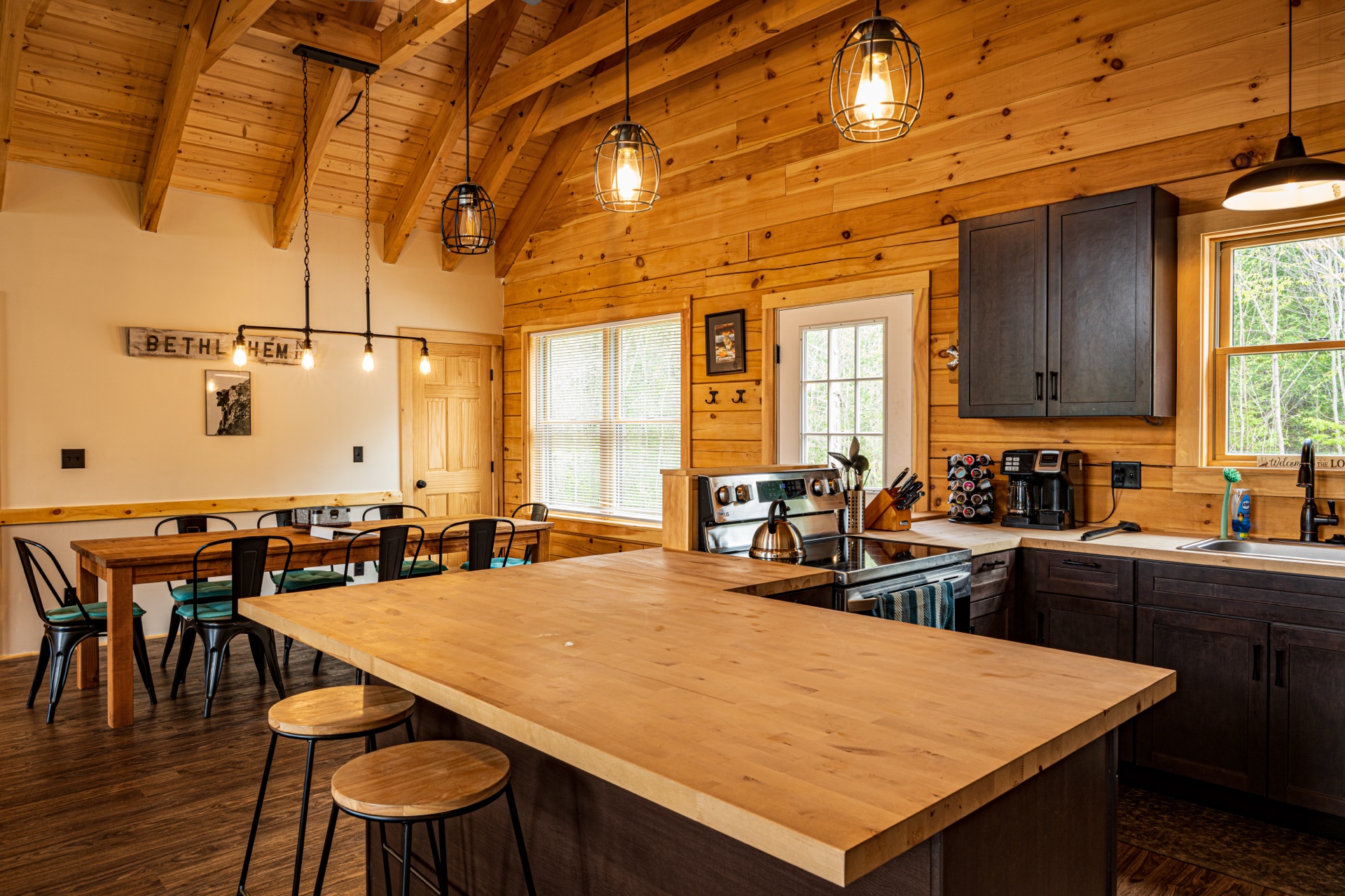 Sunapee kitchen with bar seating, dark cabinets, and stainless appliances