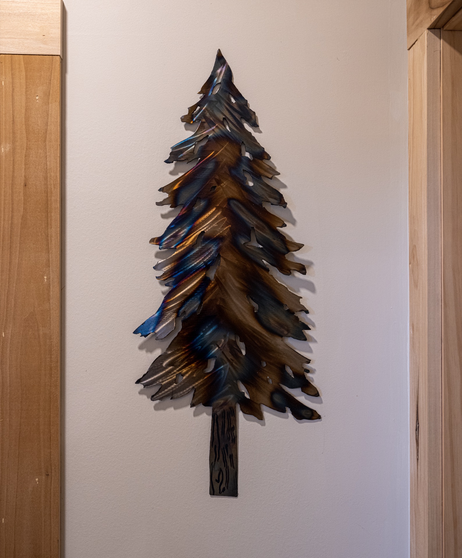 Metal pine tree wall art in the Sunapee log home